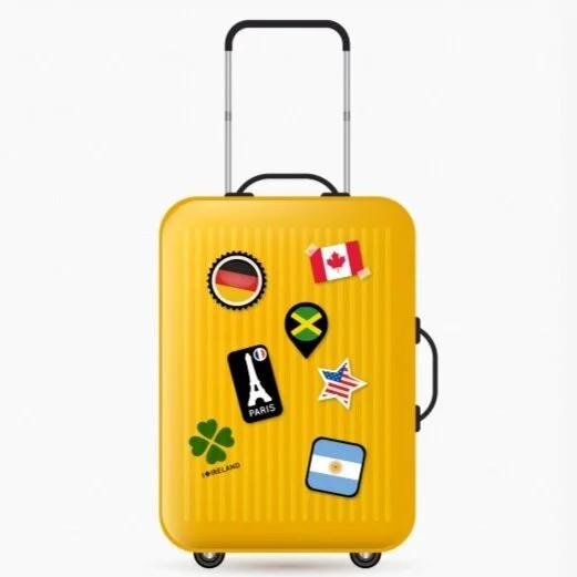 Suitcase covered in stickers from famous landmarks